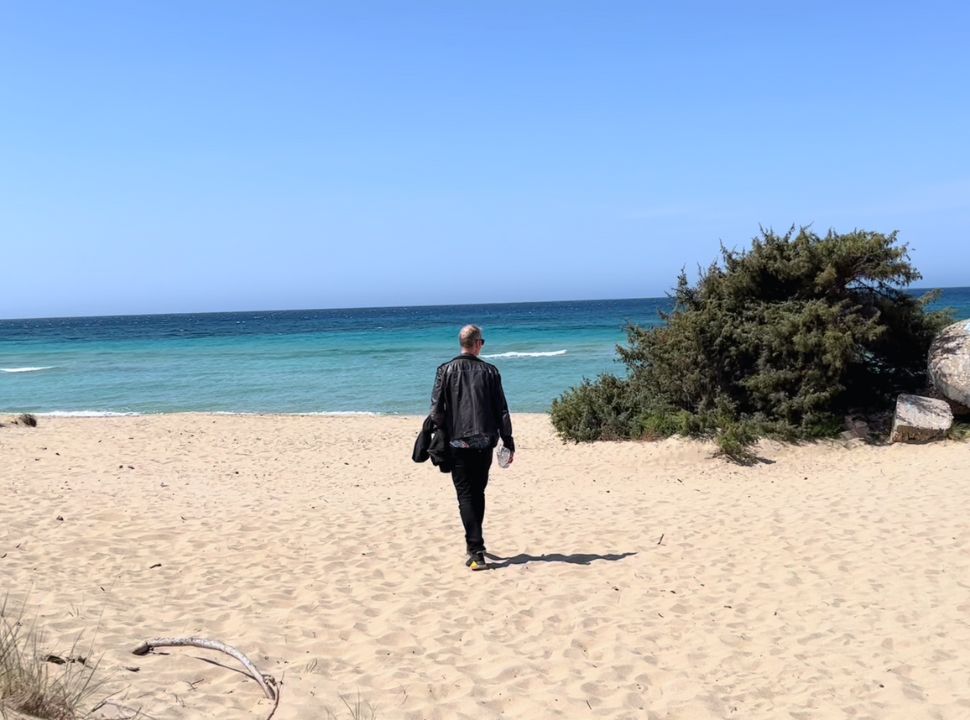 man walking on a empty beach at spiaggia pedal Bianca puglia