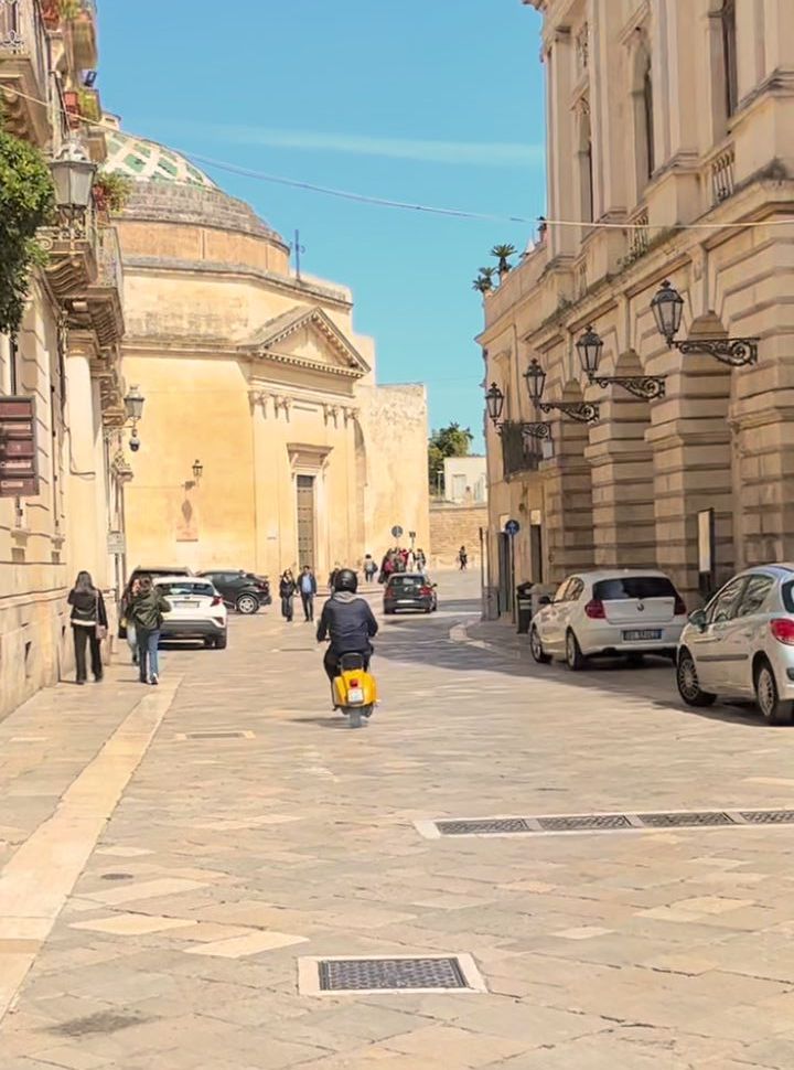 classic vespa driving the streets of Lecce in Puglia