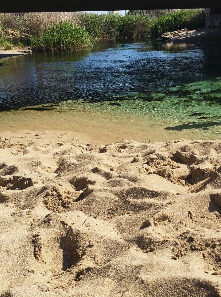 crystal clear Chidro river flowing from a nature park towards the beach