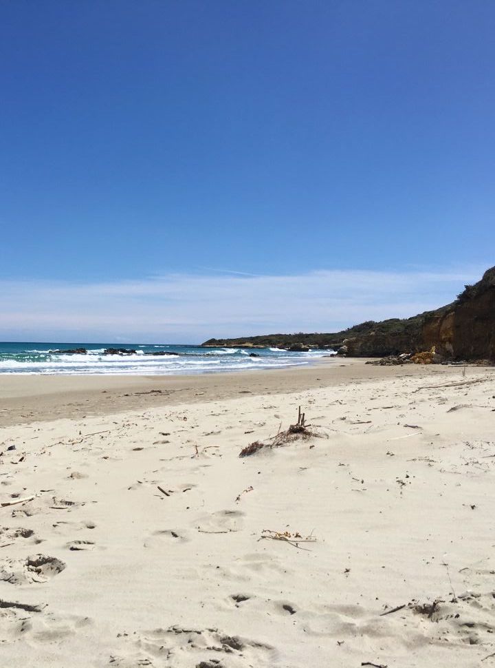 soft sanded beach with in the distance cliffs, baia dei Turchi beach Puglia