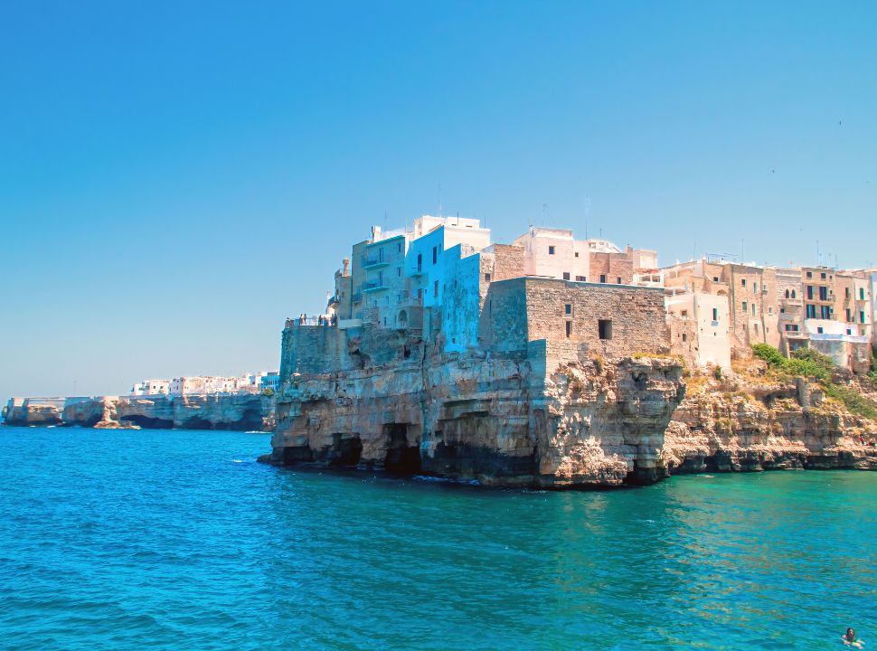 buildings built right on the cliffs edge at Polignano a mare Puglia