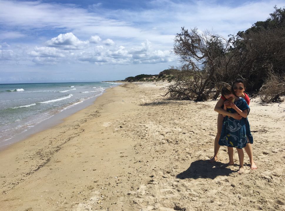 mother and son posing at a deserted beach in Puglia