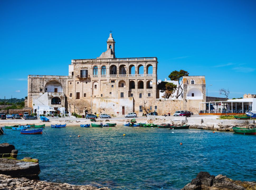 an old abbey seen from the rocks and water 