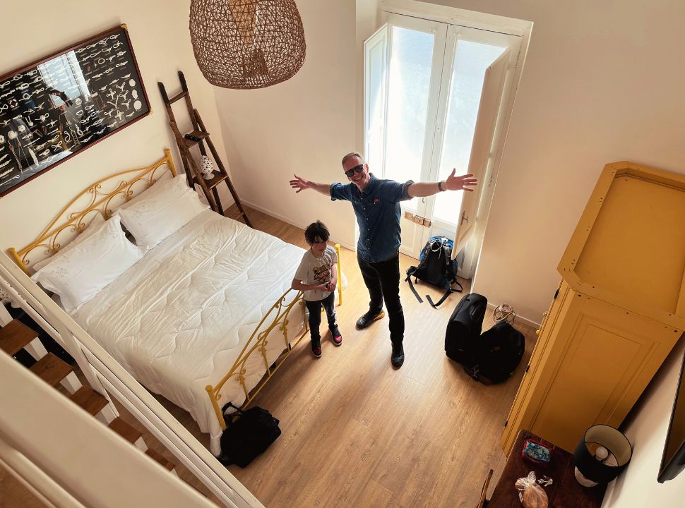 father and son standing in a room, part of an accommodation in puglia