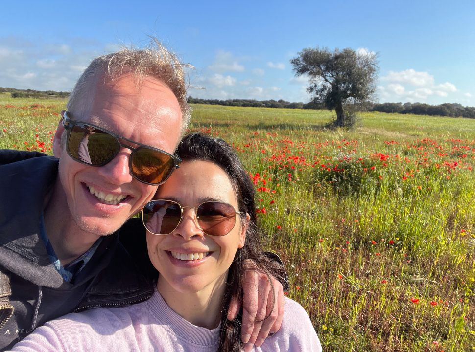 couple posing in the fields with flowers in the countryside of puglia