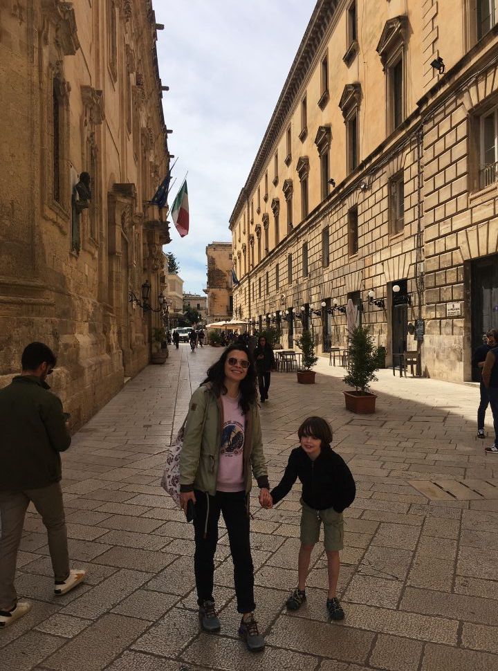 mother and son standing in one of the main streets in Lecce Puglia