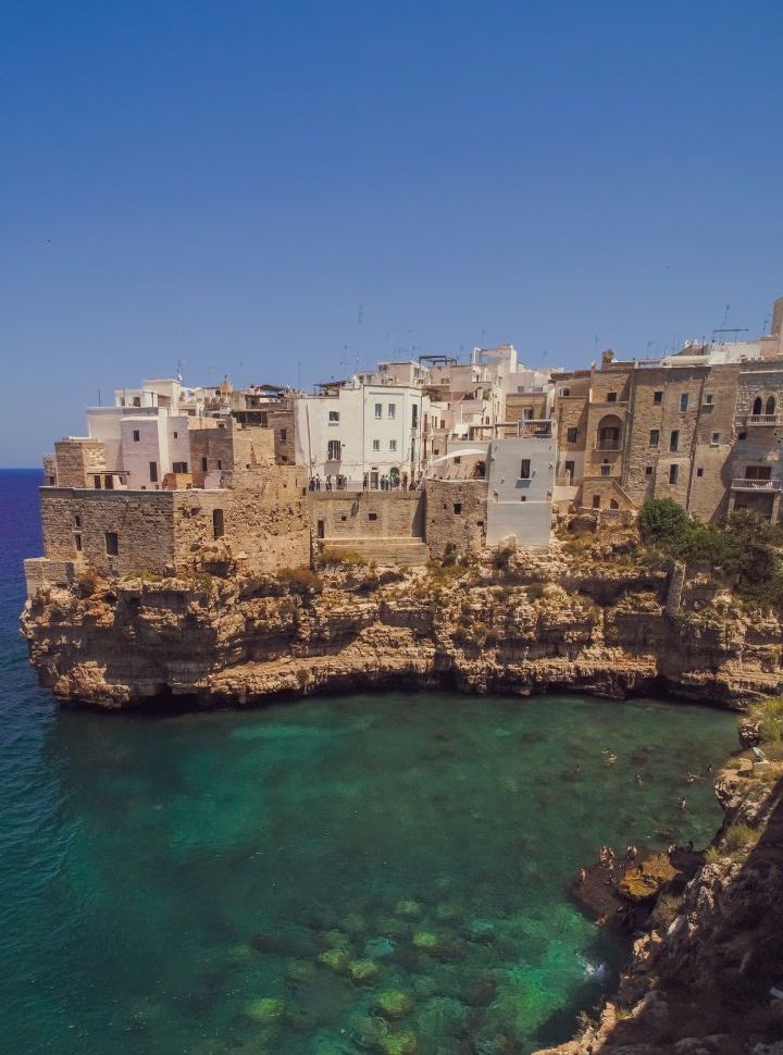 view of the buildings built on the cliff  edge at polignano a mare in Puglia Italy