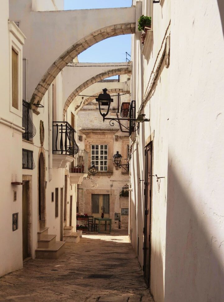 alley with the typical white buildings in polignano a mare 