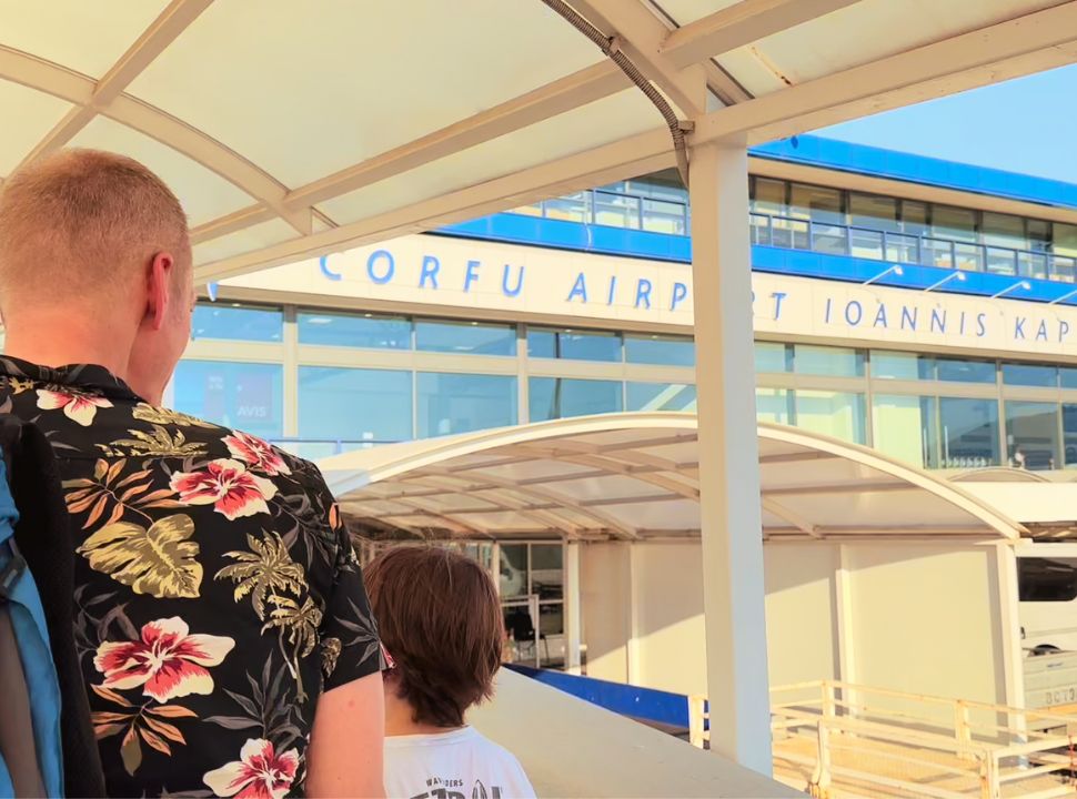 father and son arriving at the terminal of corfu airport