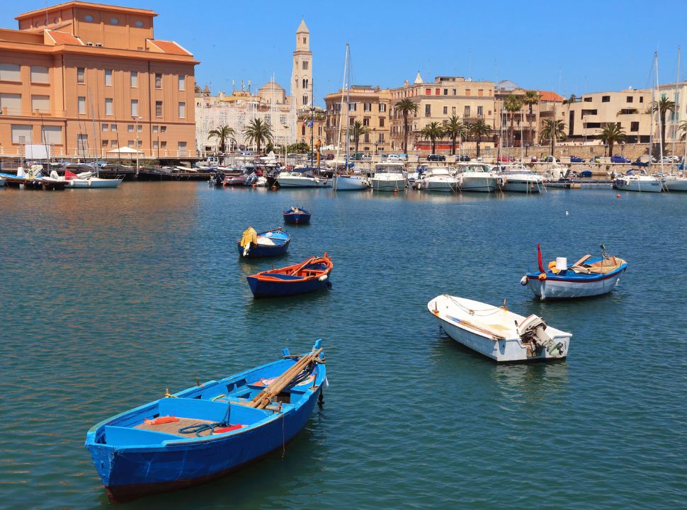 boats at the harbour in Bari Puglia with the old town in the back 