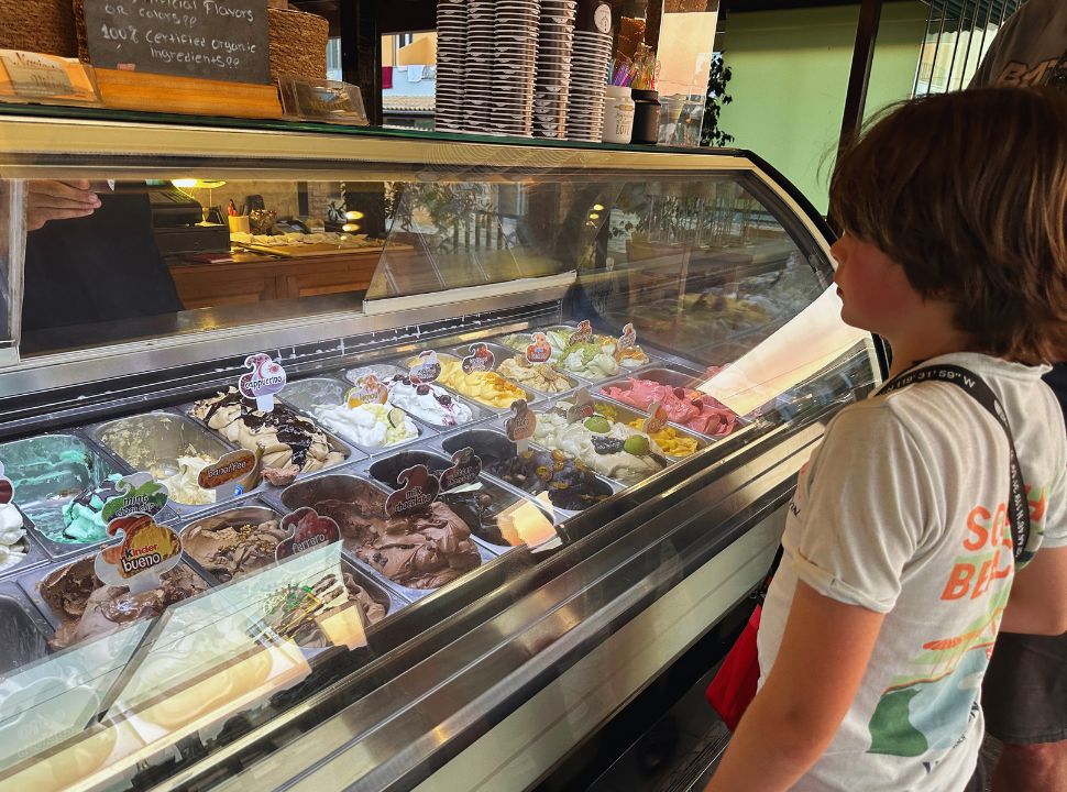 boy choosing from a large choice of ice cream flavours in corfu greece