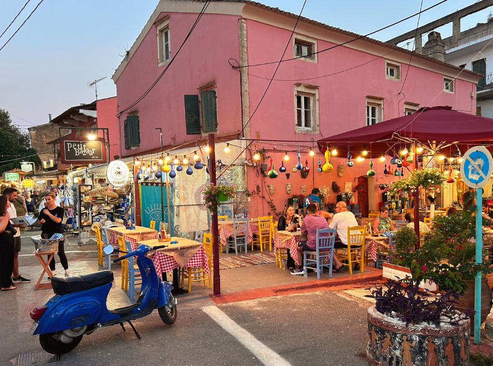 a restaurant with a colourful terrace where people are enjoying dinner in corfu