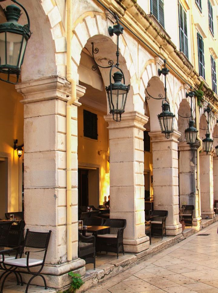 the french styled building with arches where people can have coffee and something to east, a highlight in corfu town