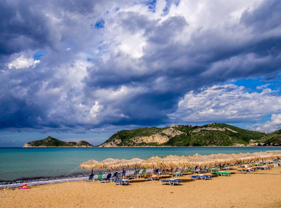 soft sandy beach with sunloungers and parasols at Agios Georgios West Corfu