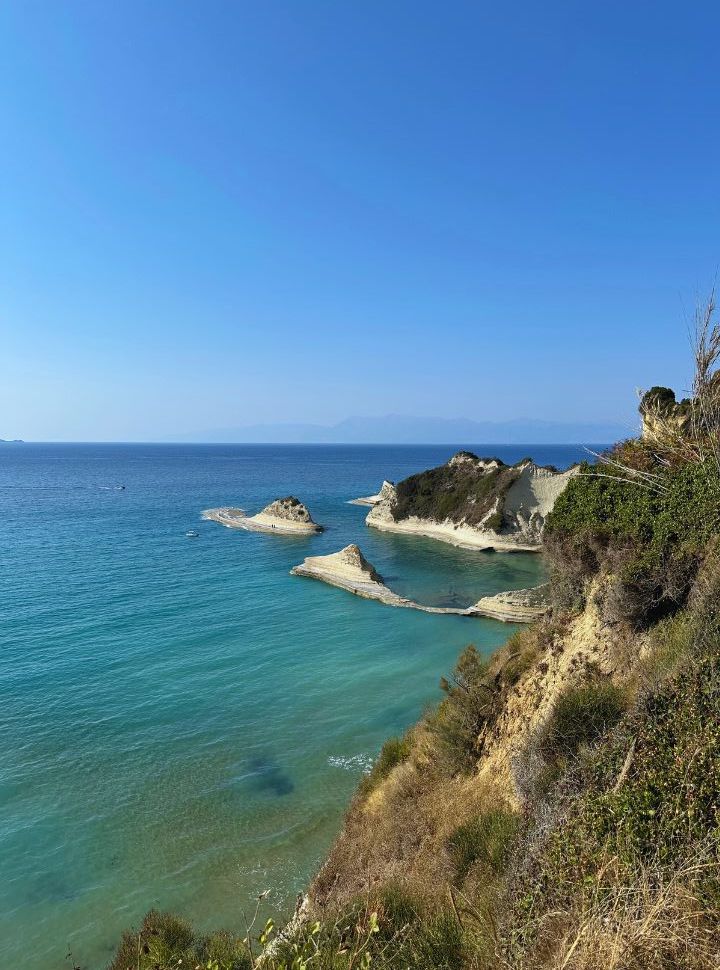 stunning view of cliffs rising from the crystal clear blue turquoise water at cape drastis corfu island