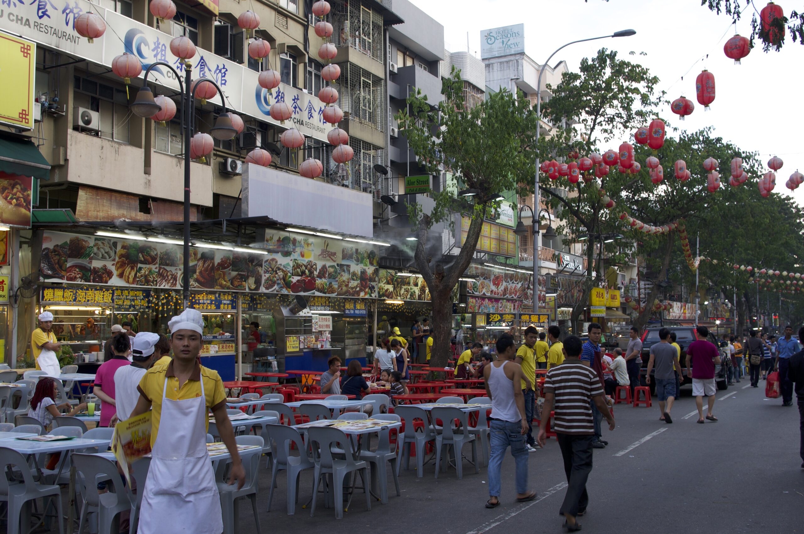 street food market with stands and tables in Kuala Lumpur