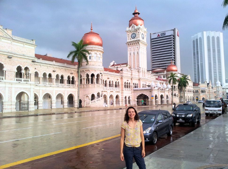 woman posing in front of a beautiful building in kuala lumpur