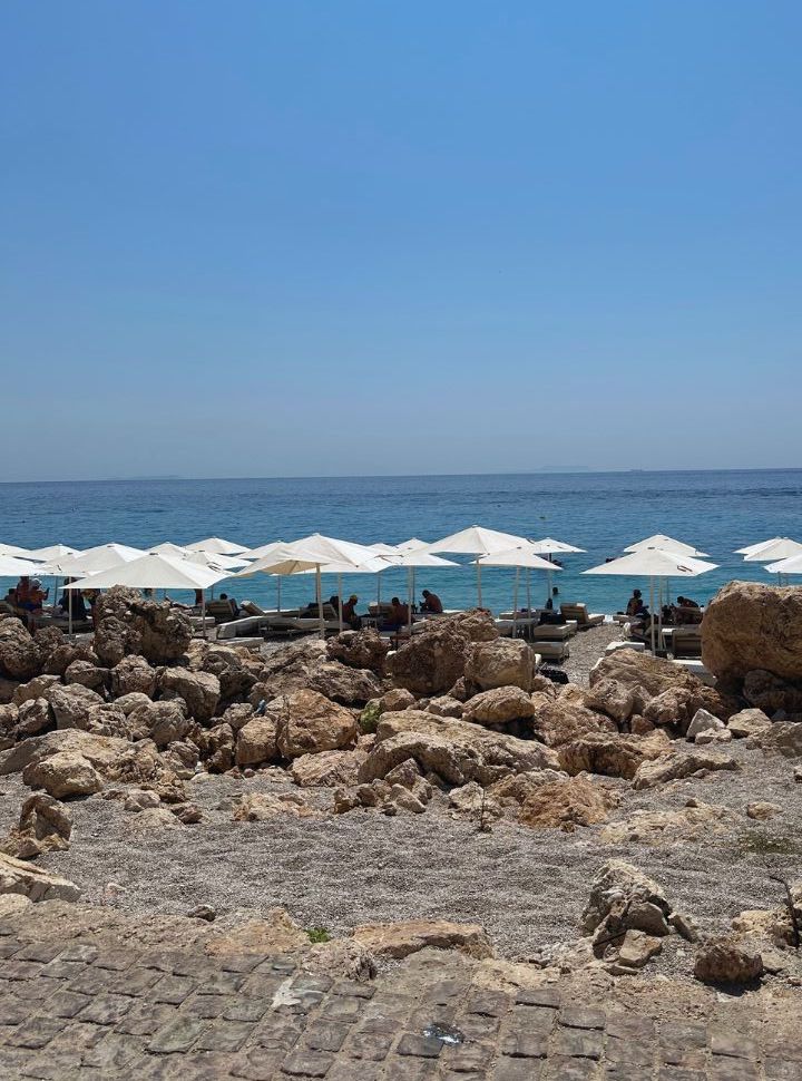 beach lounges along the waterfront at Dhermi Beach