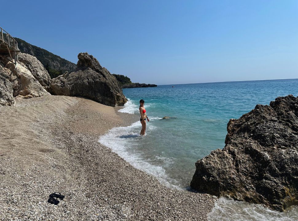 woman enjoying the water and quiet beach at Dhermi Albania