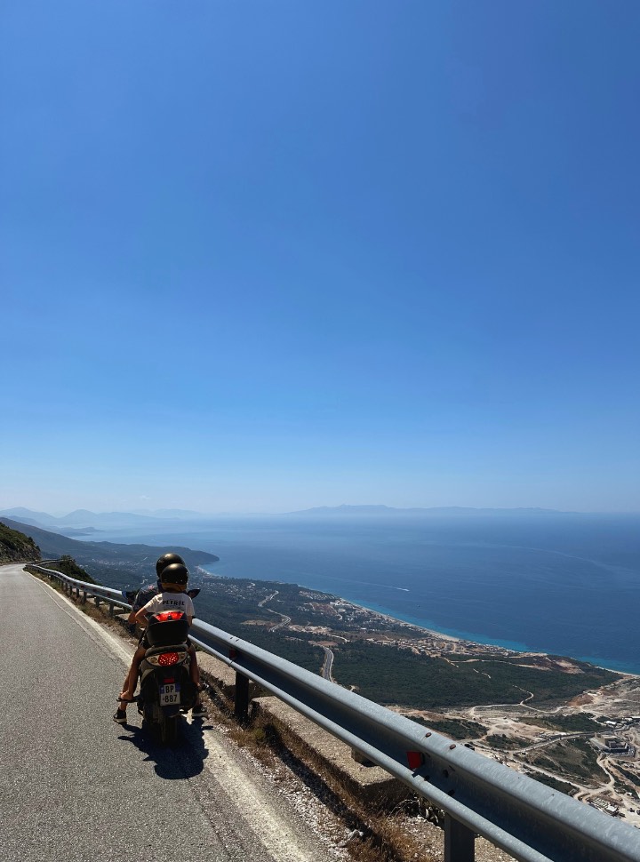 father and son stopping along the road to take in the amazing view of the ocean and mountains at Llogara pass Albania 