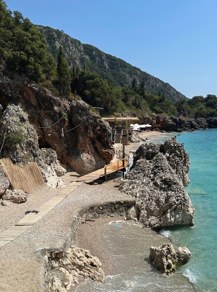 wooden path leading to a private beach with stunning water past Dhermi beach Albania