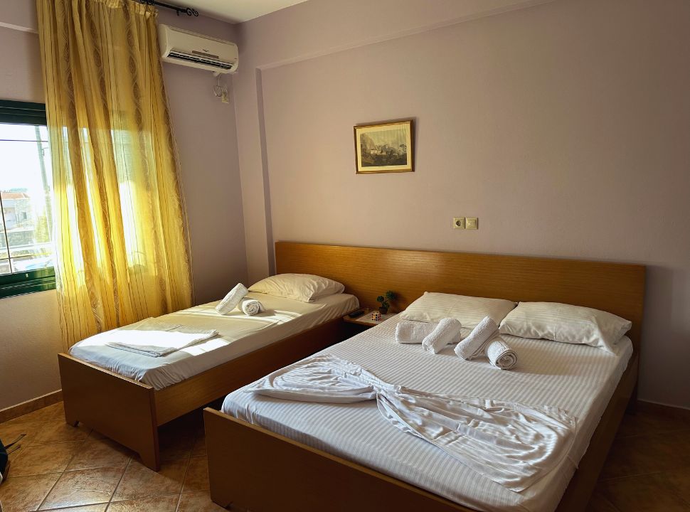 three beds in a basic yet proper room in Albania Ksamil