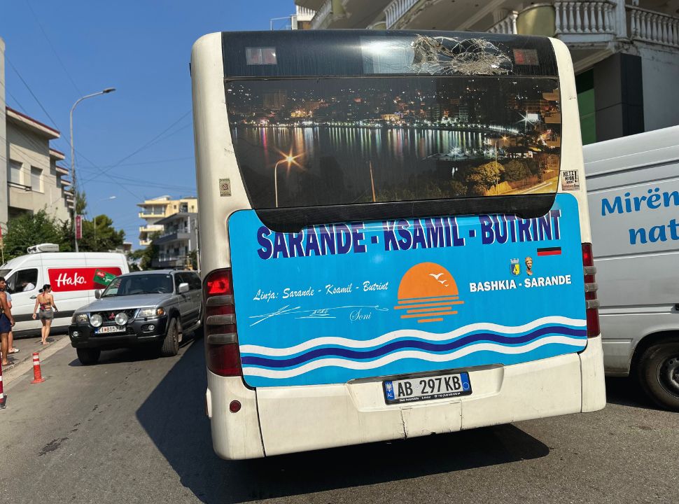 back of a local bus with huge sign showing its route Sarande-Ksamil-Butrint