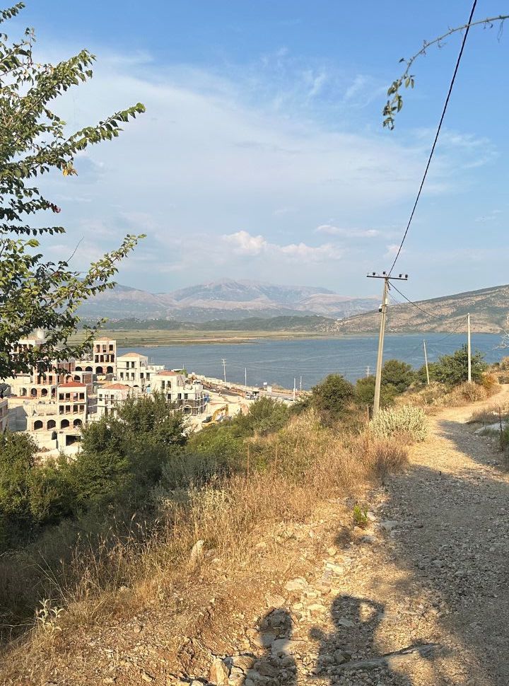 dirt road over looking a lake and the construction site of Monastery beach just outside Ksamil towards Saranda