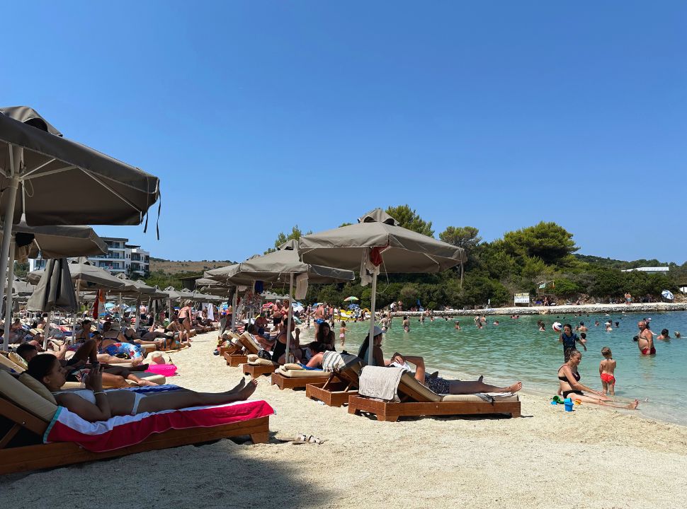 row of sun beds close to the water front at the busy Paradise beach at Ksamil Albania