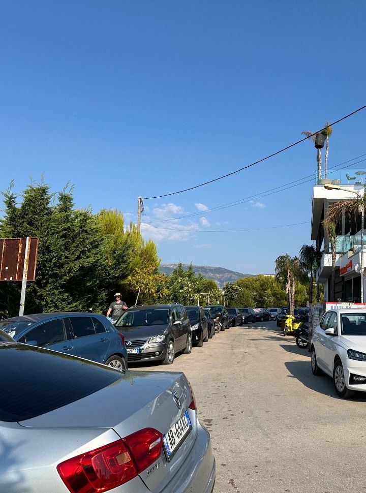 small road full with parked cars at ksamil beach Albania