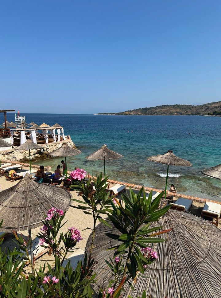 sunbeds along the waterfront of a emerald blue ocean at ksamil albania