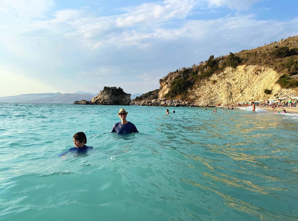 father and son enjoying the milky turquoise water at mirror beach near Ksamil Albania