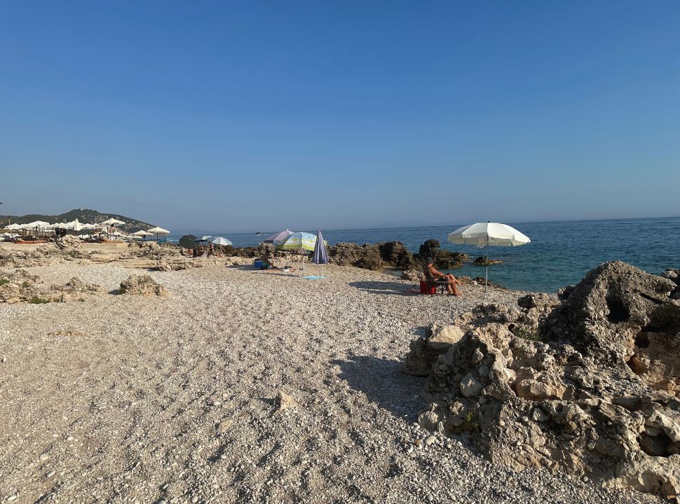 quiet beach set within rocks next to a beach restaurant at Palasa beach Albania