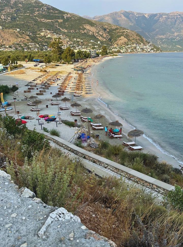 view of Qeparo beach from the coastal main road, this part is more wide providing more space for the sun loungers and there are less buildings at the beach itself