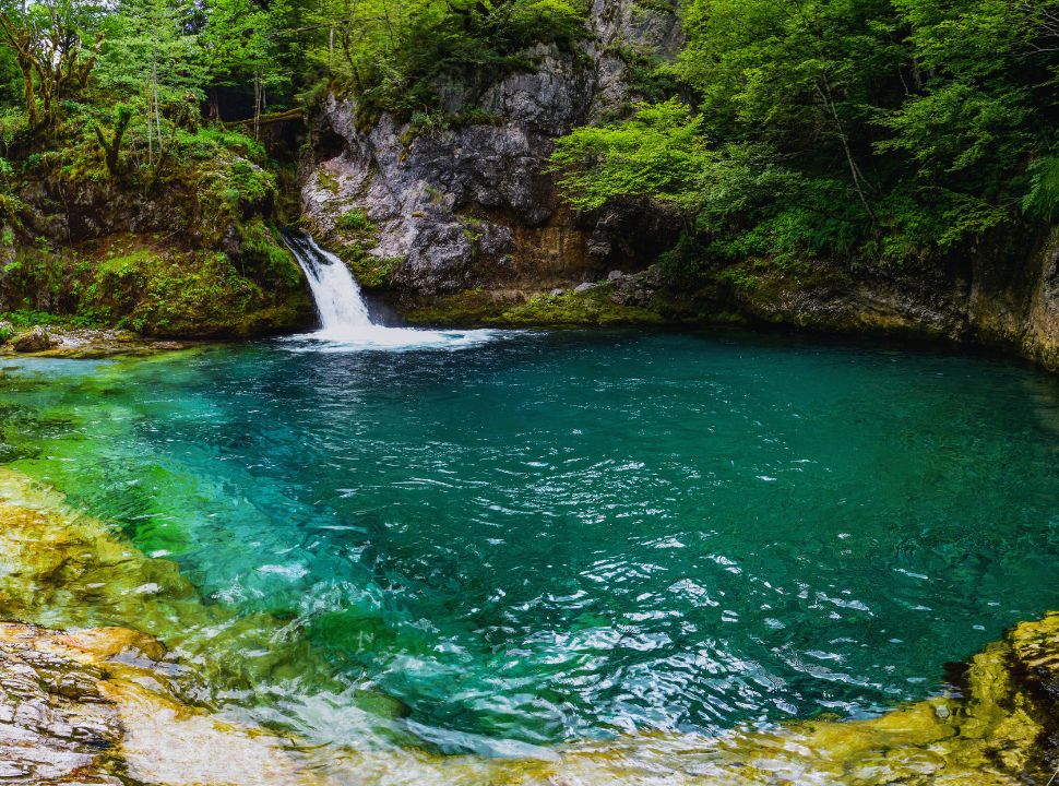 small waterfall flowing into the blue eye pool in Theth National Park Albania