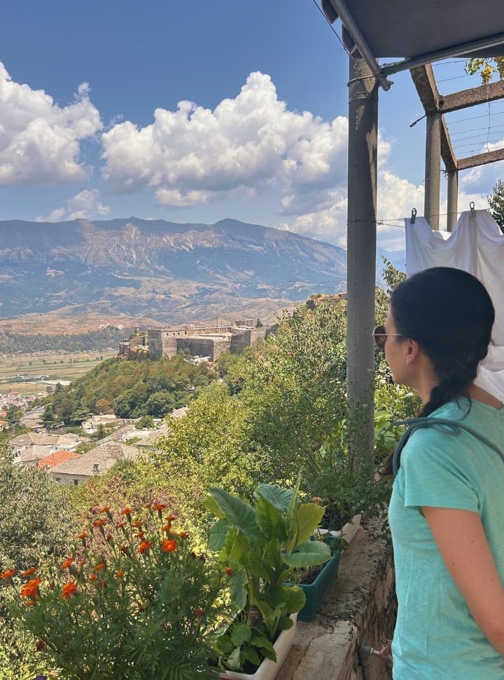 woman overlooking the valley of Gjirokaster from a varandah