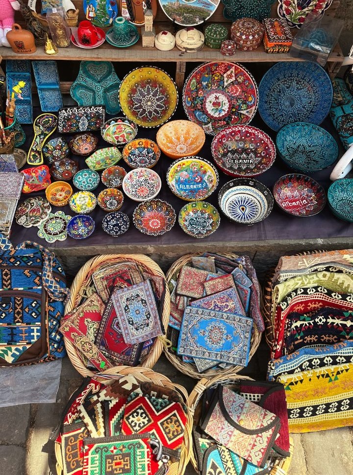 typical souvenirs sold at the bazaar in Gjirokaster: colorful plates, bags, wallets, and bowls. 