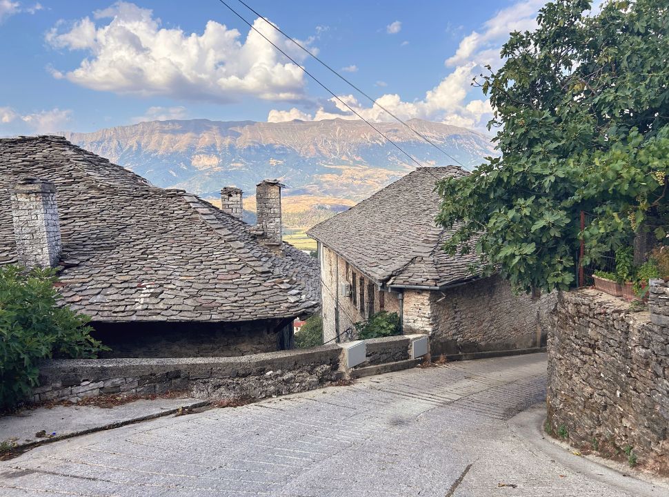 the road is steep making it possible to walk along the traditional roofs of the houses in Gjirokastër Albania