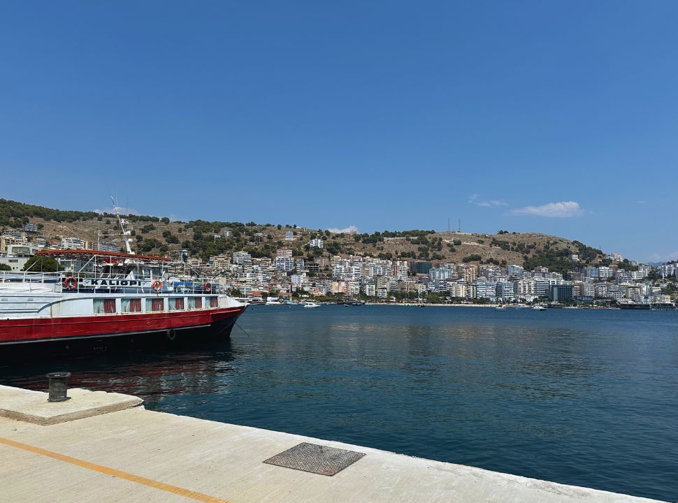 view of Saranda town from the docks at the ferry terminal, a boat is docked here as well