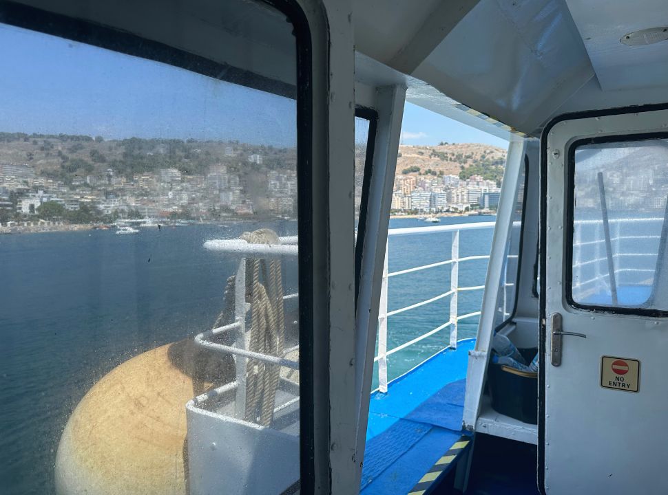 picture taken from inside the ferry but the town Saranda in Albania is visible in the distance