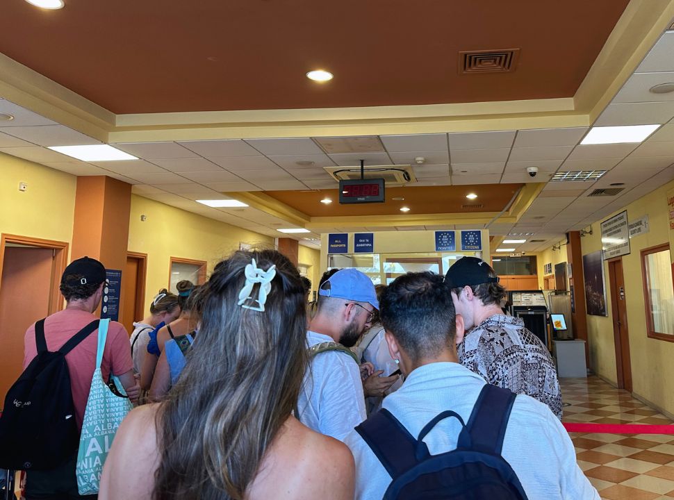 people standing in line at the passport check terminal at Corfu Port