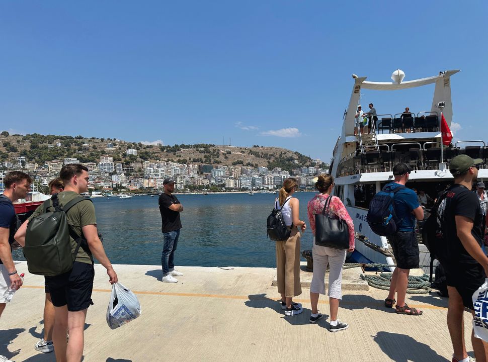 people waiting to board the ferry at the dock at Sarandë Albania