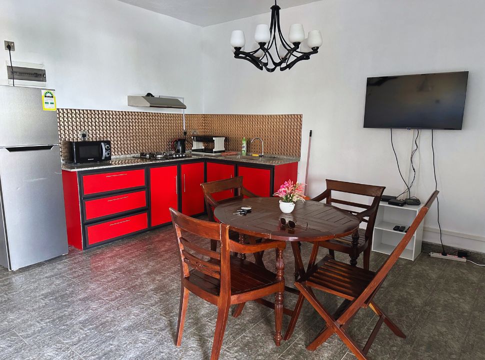 an accommodation in Mauritius with a fully equipped kitchen and dining table.