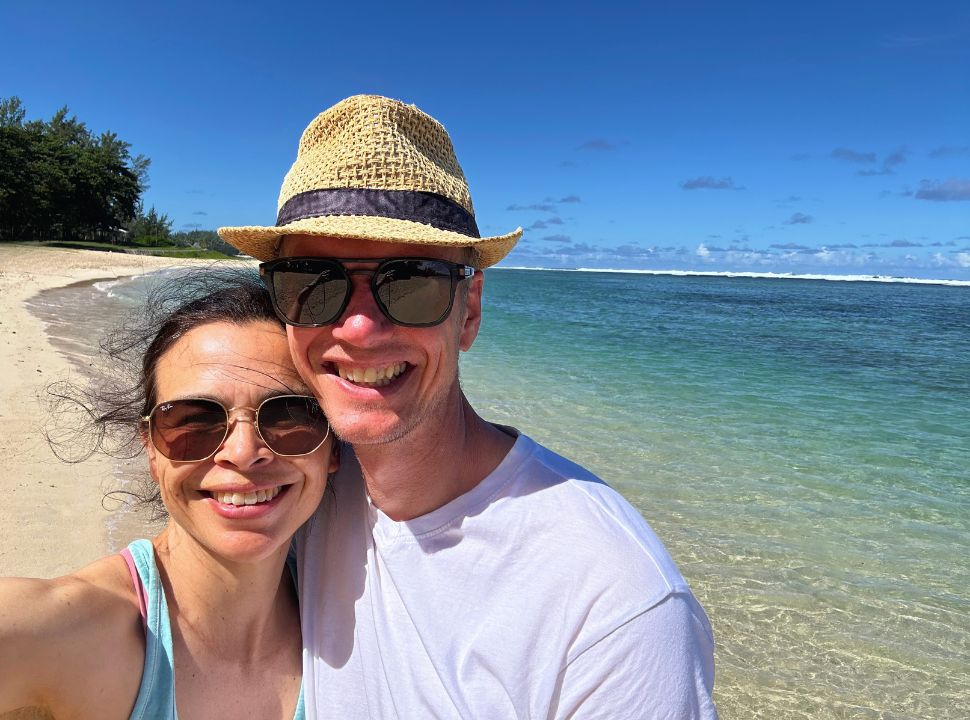 couple posing for a selfie at a stunning tropical beach