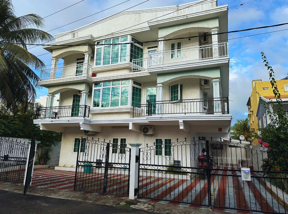 three story gated building with apartments with balcony in Mauritius.