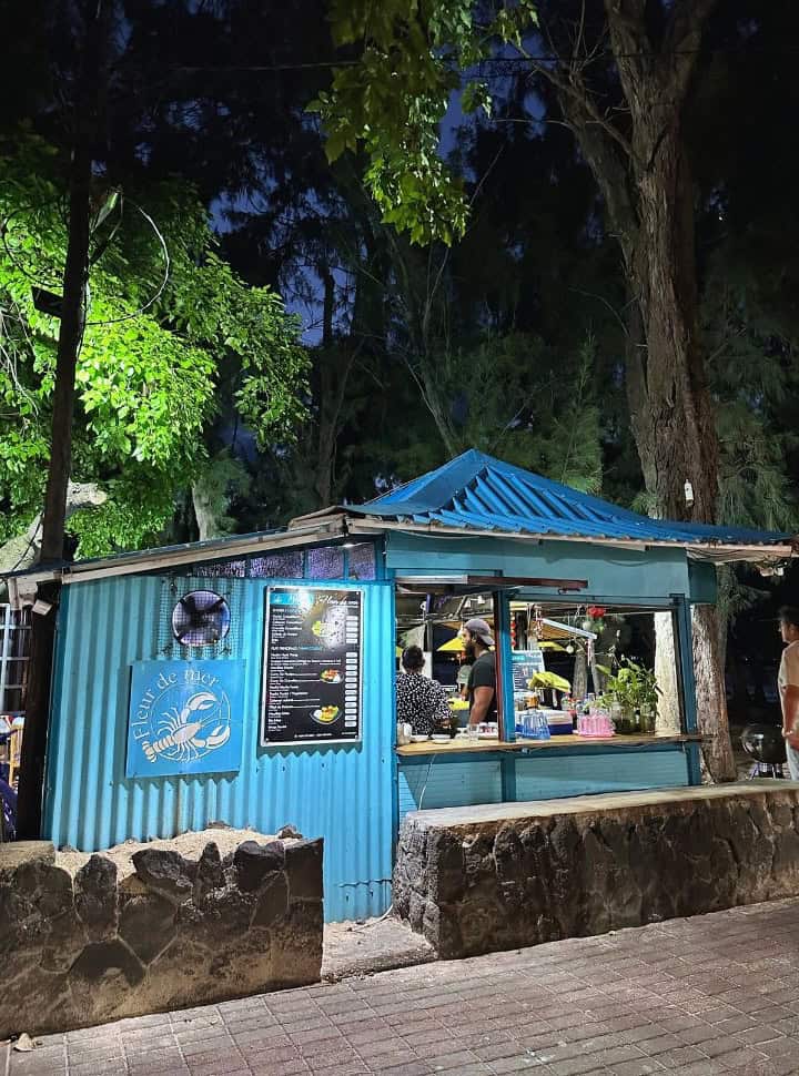 blue colored food stall under the trees at night, Mauritius travel tips stick to busy areas at night