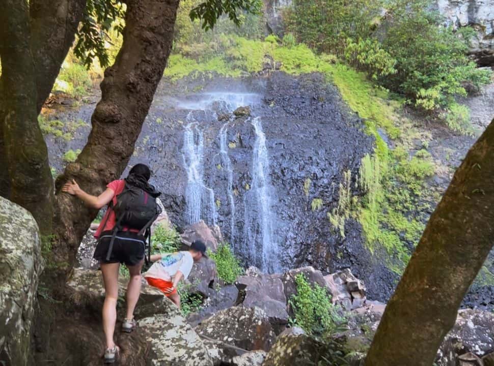mother and son arriving at a waterfall in Mauritius