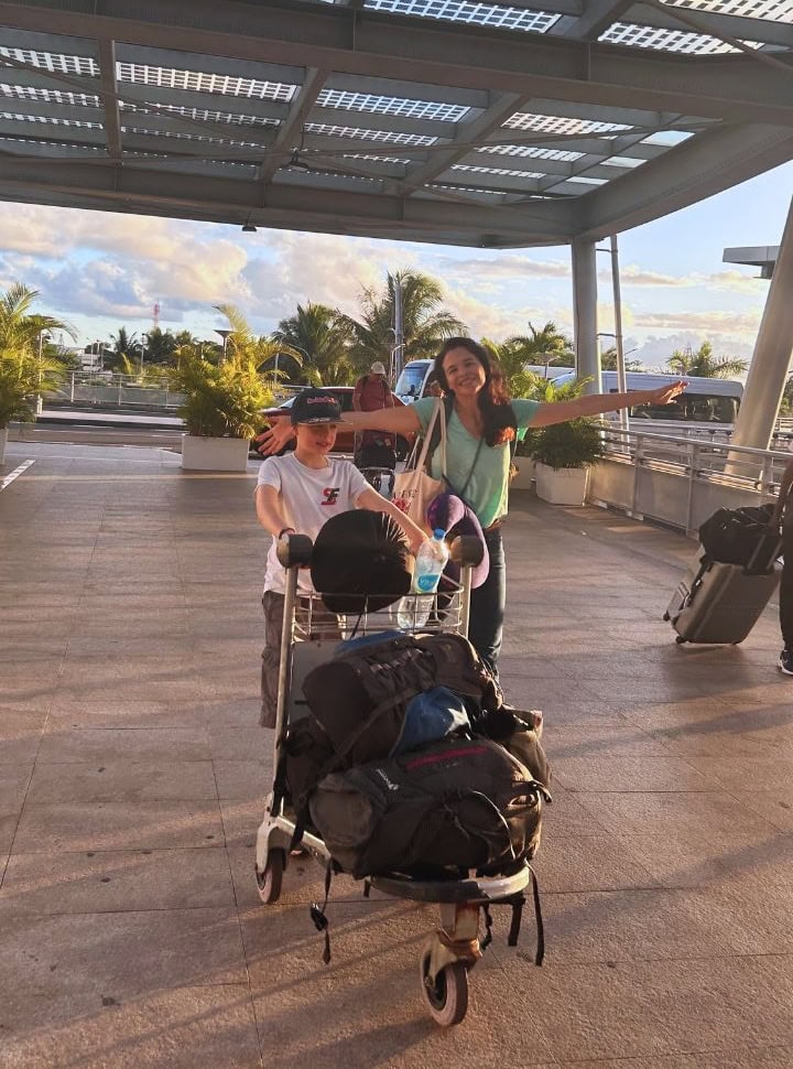 mother and son at the airport with their luggage, mauritius travel tips packing. 