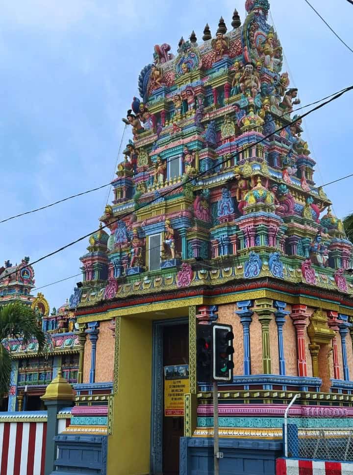entrance to a hindu temple decorated in all sorts of decorations and statues in various colors near Gran Baie Mauritius