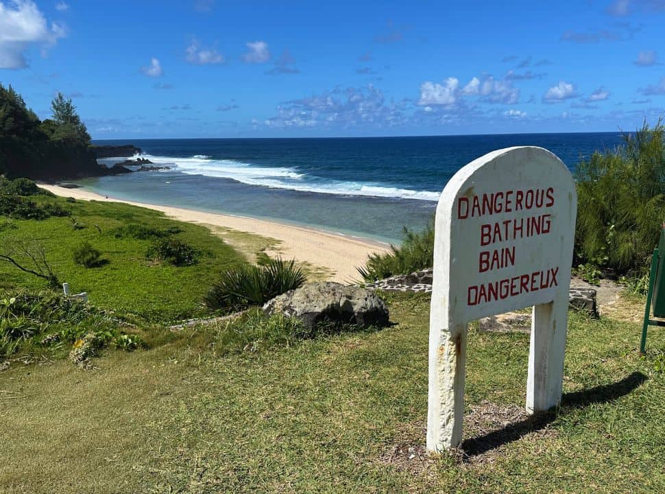 sign just before the stairs towards Gris Gris beach stating: dangerous bathing in english and french